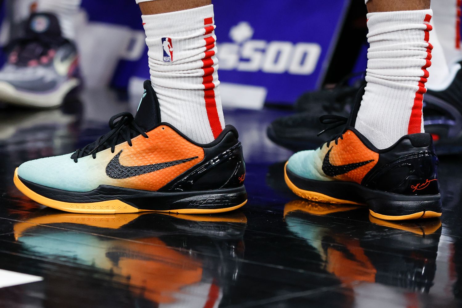 View of black and orange Nike Kobe shoes.